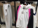a rack of clothing in a clothing store with clothes hanging on it