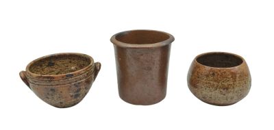 three brown vases sitting next to each other on a white surface