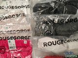 several pairs of red, white, and black socks are wrapped in plastic