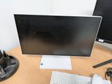 a computer monitor and keyboard on a desk