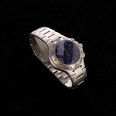 a silver watch with a blue face on a black background