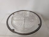 a clear glass plate with a silver rim on a clear surface