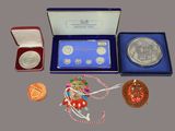 a box with a medal, a medal, a medal, a medal, a medal, and a medal in it