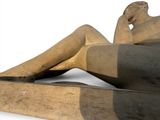 a statue of a woman sitting on a bench