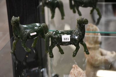 a glass display case with a lot of figurines of animals