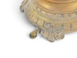 a gold vase with a clock on it on a white surface