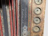 a close up of an old accordion with buttons on it