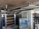 a large room with a lot of ovens and other appliances