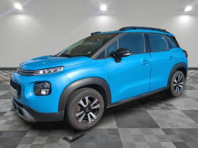 a blue citrole is parked in a room with a checkered floor