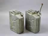 pair of metal jerry canisters with screws on top of them