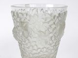 a glass vase with a flower design on it