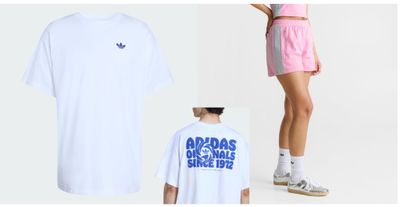 a woman standing next to a t - shirt and shorts