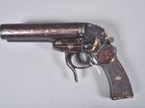 a gun that is sitting on a white surface