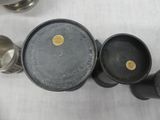 four cups and a saucer on a table next to each other