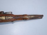 an old gun with a wooden handle on a white surface