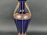 une image représentant un vase bleu orné de motifs dorés