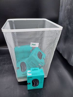 a trash can with a camera in it next to a trash can