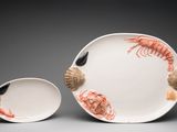 a white plate with shrimps and shells on it