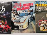 three racing books on a table with a number of racing cars