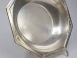 an antique silver plate on a stand on a white background