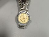 a person holding a watch with a chain around it