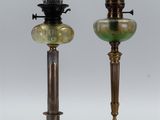 pair of antique brass and green glass lamps on pedestals