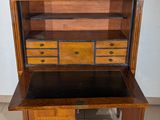 a wooden cabinet with drawers and a marble top