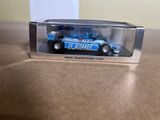 a small toy car in a clear box on a table