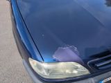 a car that has been damaged and is parked on the street