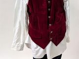 a mannequin dressed in a red vest and black boots