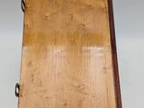 an old wooden box with a handle on a white background