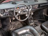 a dashboard of a car with a steering wheel and a dash board