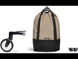 a backpack with a handlebar attached to it next to a stroller