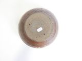 a brown vase with a tag on it