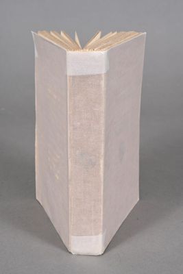 an open book sitting on top of a table next to a gray background