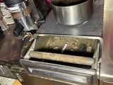 stainless steel counter top with a fryer and a pot on it