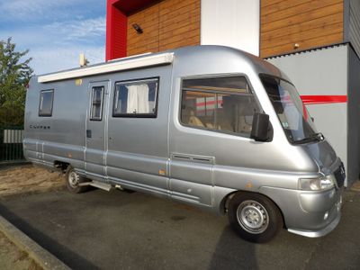 a silver van that is parked in front of a building