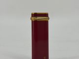 an image of a red and gold container on a white surface