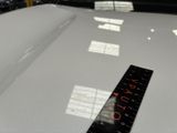 a ruler on the hood of a car that is parked in a garage