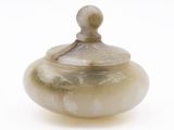 a picture of a small glass jar with a lid