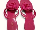pink chanel sandals with a flower on the side of them