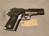 an old gun with a note attached to it on a table