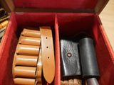 a red box with a belt and other items in it