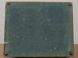 an old blue suitcase sitting on top of a wooden table