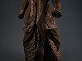 an image of a brown dress and coat on a mannequin stand