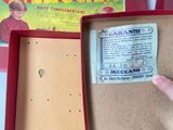 a person holding a box with a ticket inside of it