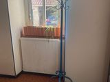 a blue coat stand in the corner of a room
