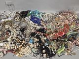 a pile of assorted jewelry sitting on a table