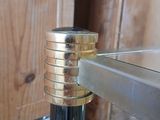 a close up of a black and gold pipe on a table
