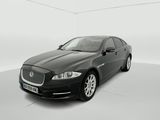 a black jaguar parked in a white room with a white background